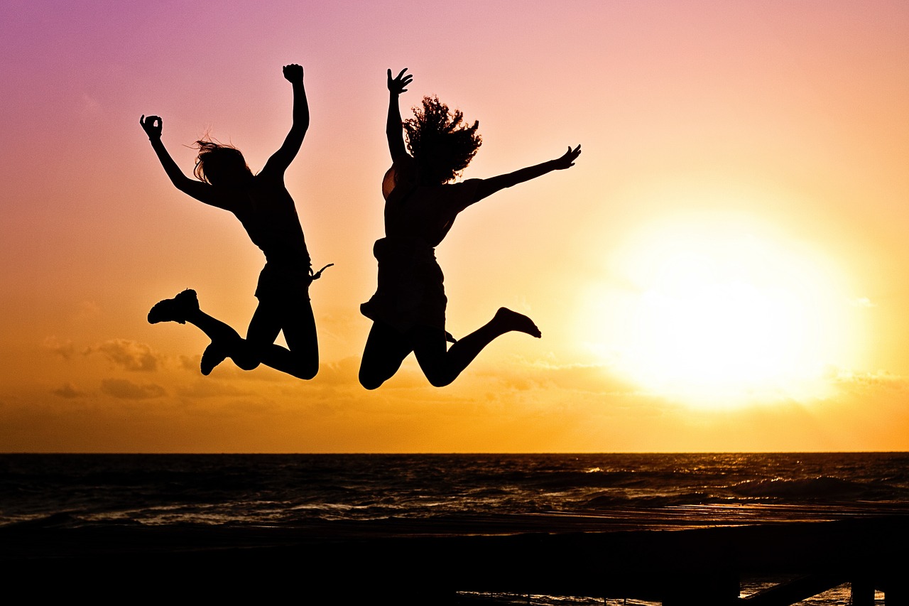 People jumping in sunset on a beack